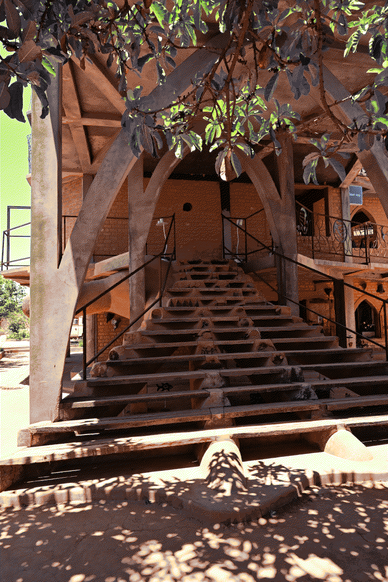 Photo de l'escalier menant aux étages du batiment principal, comportant de nombreuses décorations et objets incrustés